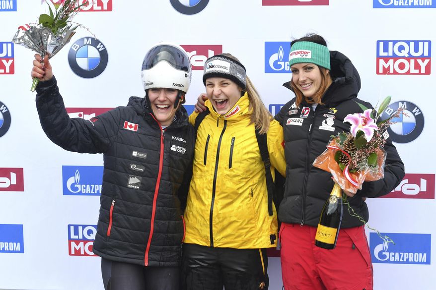 Germany's winner Tina Hermann, center, Canada's second placed Mirela Rahneva, left, and Austria's third placed Janine Flock pose for media after the women's Skeleton World Cup race in Igls, near Innsbruck, Austria, Friday, Feb. 3, 2017. (AP Photo/Kerstin Joensson)