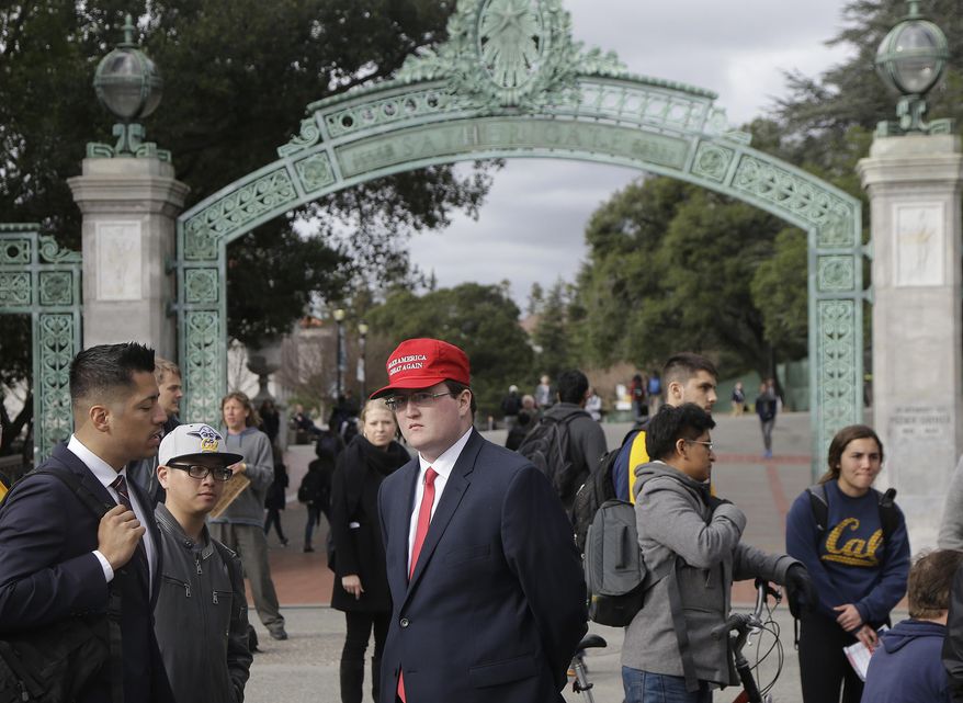 University of California, Berkeley, student Jack Palkovic, center, stands with others near a Berkeley College Republicans table in front of Sather Gate on campus in Berkeley, Calif., Thursday, Feb. 2, 2017. Palkovic said he was attacked on the campus a day after violent protests led authorities to cancel a controversial speech. (AP Photo/Jeff Chiu)