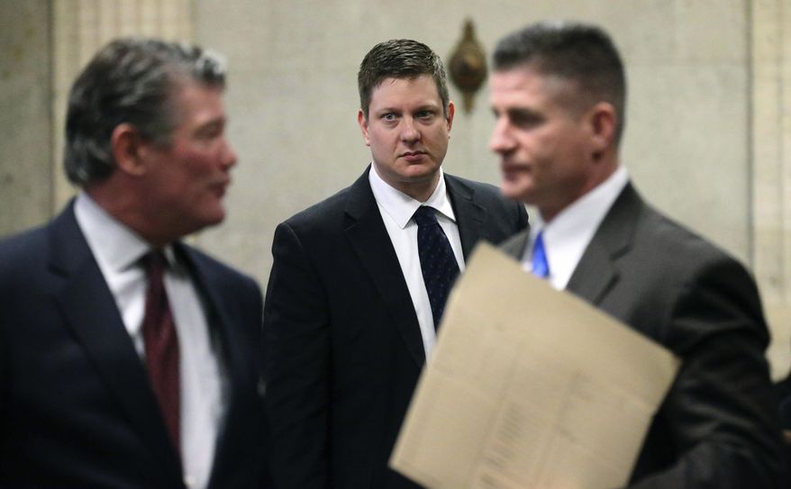 Chicago police officer Jason Van Dyke, center, attends a status hearing at the Leighton Criminal Court building Friday, Feb. 3, 2017. Van Dyke is in court on charges of first-degree murder in the shooting of Laquan McDonald. (Antonio Perez /Chicago Tribune via AP, Pool)