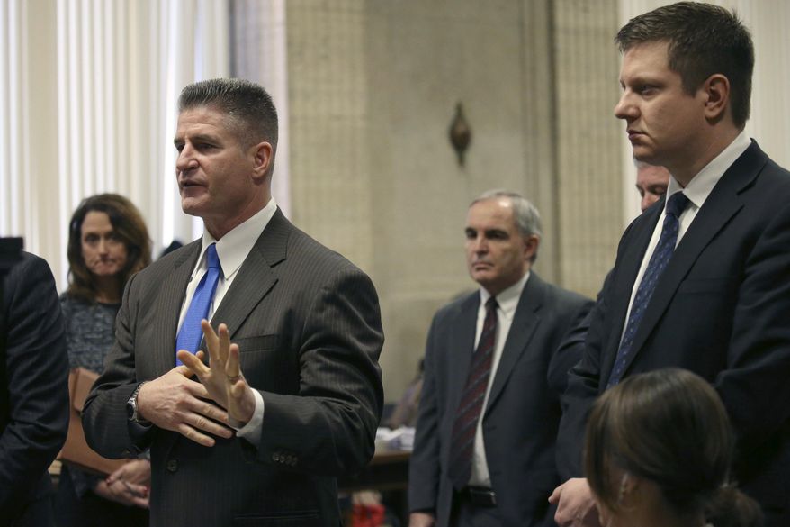 Chicago police officer Jason Van Dyke, right, and attorney Dan Herbert attend a status hearing at the Leighton Criminal Court building Friday, Feb. 3, 2017. Van Dyke is attending court on charges of first-degree murder in the shooting of Laquan McDonald. (Antonio Perez /Chicago Tribune via AP, Pool)