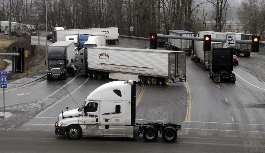 CORRECTS FROM INTERSTATE 5 TO INTERSTATE 84- A handful of entangled semi trucks block a stretch of an icy road just off Interstate 84 in Troutdale, Ore., Friday, Feb. 3, 2017. Freezing rain has caused many crashes in the Portland and Columbia River Gorge areas. (AP Photo/Don Ryan)