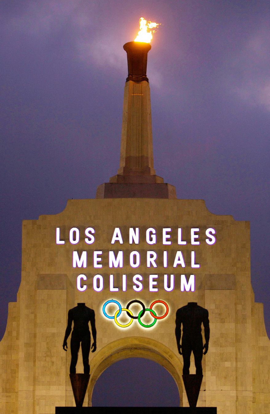 FILE - This Feb. 13, 2008, file photo shows the facade of Los Angeles Memorial Coliseum in Los Angeles. Los Angeles Olympic planners competing for the 2024 Games promised Thursday, Feb. 2, 2017, to help restore credibility and stability to international sports festival as the world enters an era of uncertainty. In documents submitted to the International Olympic Committee, the privately run group known as LA2024 said it had crafted a "no surprises" plan that will closely watch the financial bottom line. (AP Photo/Jae C. Hong, File) (AP Photo/Damian Dovarganes, File)