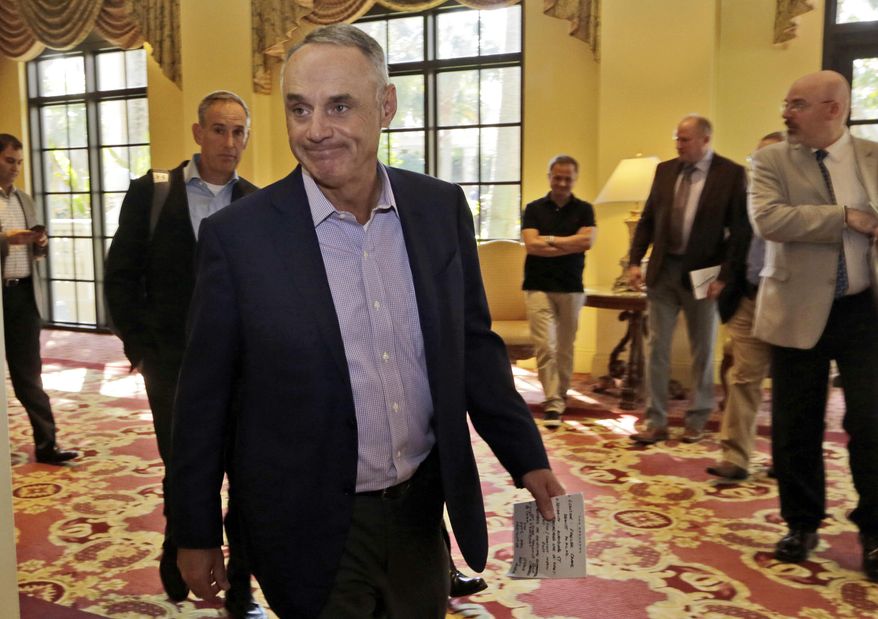 Major League Baseball Commissioner Rob Manfred walks to a news conference following a meeting with MLB owners, Friday, Feb. 3, 2017, in Palm Beach, Fla. (AP Photo/Lynne Sladky)