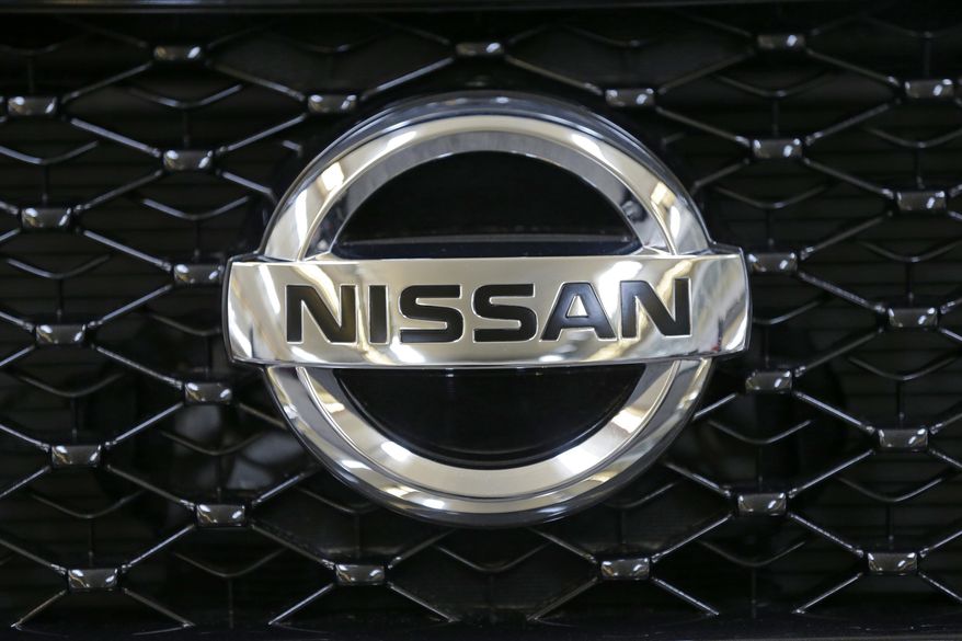 FILE - This Feb. 14, 2013 file photo shows the Nissan logo on the grill of a 2013 Nissan Pathfinder on display at the 2013 Pittsburgh Auto Show in Pittsburgh. The company is recalling more than 341,000 of the midsize cars in the U.S. because the doors might open if a rear window is lowered.The recall covers Altimas from the 2015 through 2017 model years. (AP Photo/Gene J. Puskar, File)