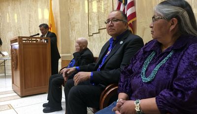 Guests of honor Darlene Arviso, far right, of the Navajo Nation and Robert Taken Alive of the Standing Rock Sioux tribe visit the New Mexico Statehouse in Santa Fe as guests of honor on Friday, Feb. 3, 2017. Local Native American leaders signed a letter to President Donald Trump expressing solidarity with the Standing Rock Sioux and other opponents of the Dakota Access oil pipeline project. The annual Native American day in the state capital focused on water issues and recognized Arviso her work delivering water free of charge to rural residents without access to running water. (AP Photo/Morgan Lee)