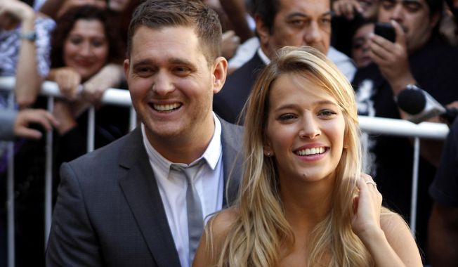 FILE - This March 31, 2011 file photo shows Canadian pop star Michael Buble, left, Argentine actress Luisana Lopilato in Buenos Aires, Argentina. Buble and Lopilato said on Feb. 3, 2017, that their 3-year-old son Noah “has been progressing well during his treatment” for cancer. (AP Photo/Natacha Pisarenko, File)