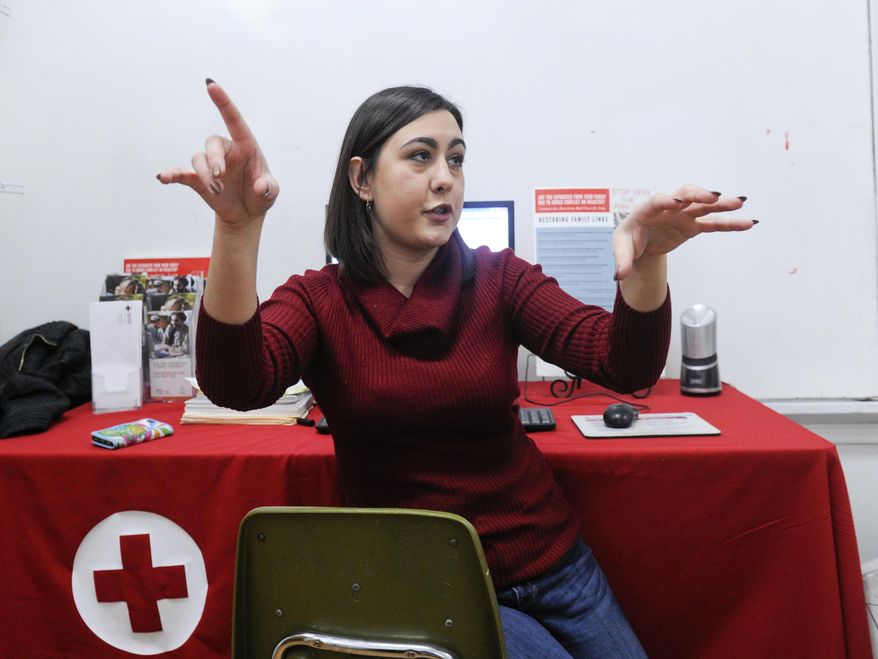 In this Jan. 31, 2017 photo, Bosnian refugee Hana Selimovic, a volunteer at the Mohawk Valley Resource Center for Refugees in Utica, N.Y., talks about the refugee-owned businesses in the town, while working at the refugee center. Utica has been a refugee "oasis" for decades. Vietnamese, Bosnians, Somalians and Burmese have each found shelter in the city that has benefited from the infusion of house-proud residents who work in hospitals, factories and their own businesses. But now President Donald Trump's executive order crimping the flow of refugees has sent a shudder through the city. (AP Photo/Hans Pennink)