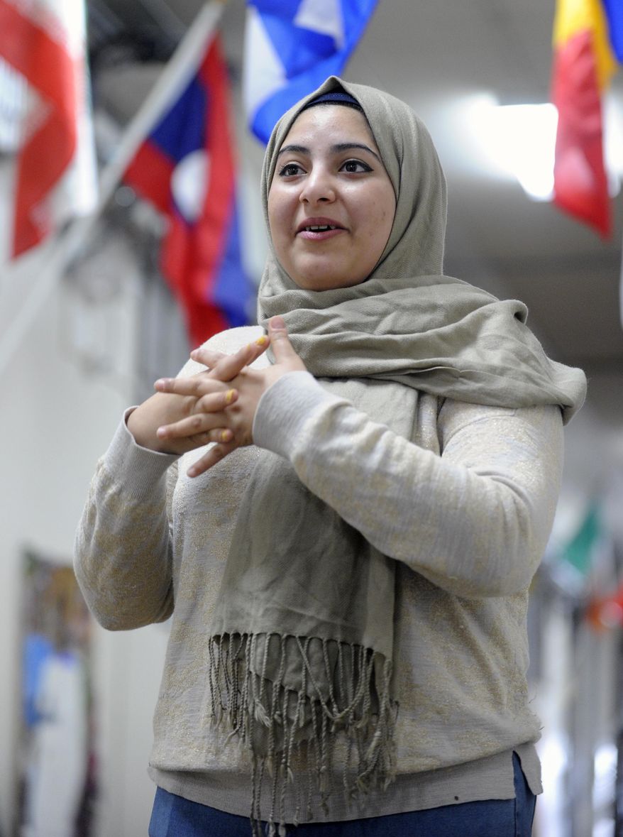 In this Jan. 31, 2017 photo, Palestinian refugee Manal Alawsaj, who was born in Iraq, speaks about her life and path to U.S. citizenship at the Mohawk Valley Resource Center for Refugees, in Utica, N.Y. The upstate New York city, that has gained new life from refugees, is looking at a sharp decrease in arrivals under President Donald Trump’s executive order restricting refugees and travel from Muslim countries. (AP Photo/Hans Pennink)