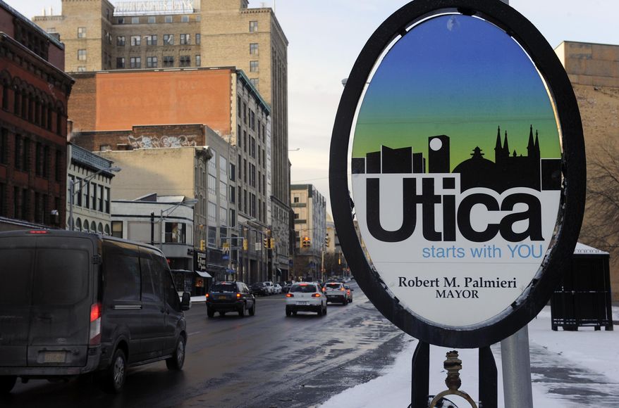 In this Jan. 31, 2017 photo, vehicles move along Genesee Street in the early morning after a fresh snowfall, in Utica, N.Y. The upstate New York city, that has gained new life from refugees, is looking at a sharp decrease in arrivals under President Donald Trump’s executive order restricting refugees and travel from Muslim countries. (AP Photo/Hans Pennink)