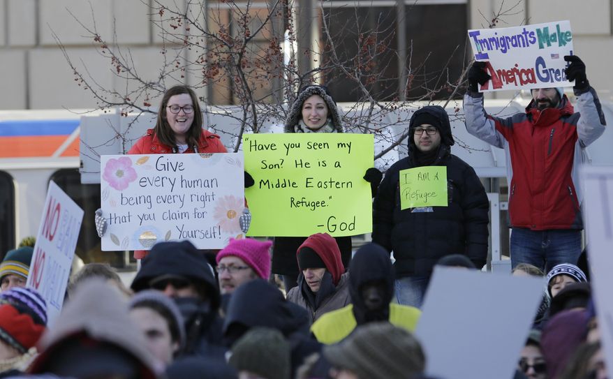 People protest at a demonstration in Market Square, Friday, Feb. 3, 2017, in Cleveland. The demonstration was organized in protest of President Donald Trump's immigration order. (AP Photo/Tony Dejak)
