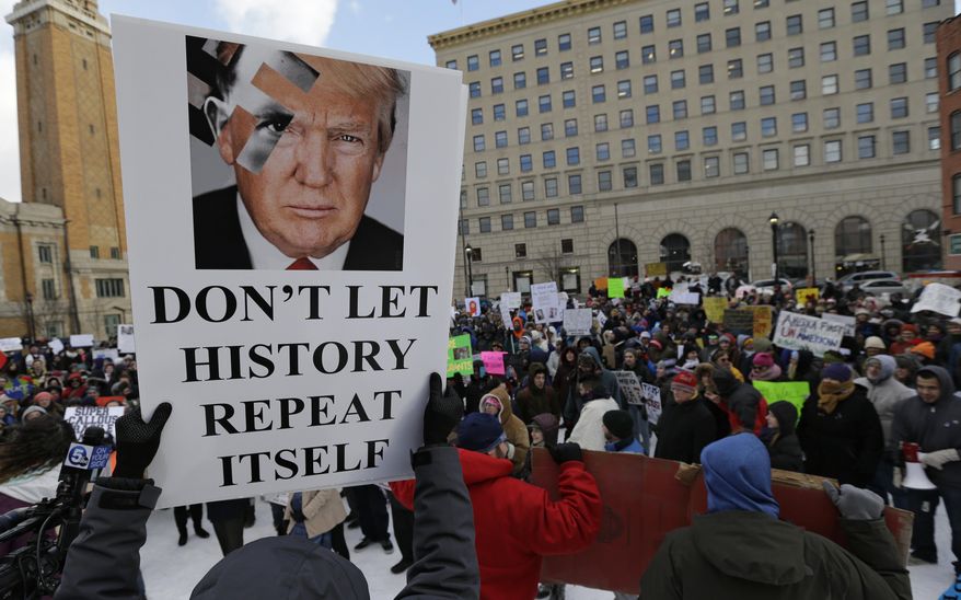 People protest in a demonstration at Market Square, Friday, Feb. 3, 2017, in Cleveland. The demonstration was organized in protest of President Donald Trump's immigration order. (AP Photo/Tony Dejak)