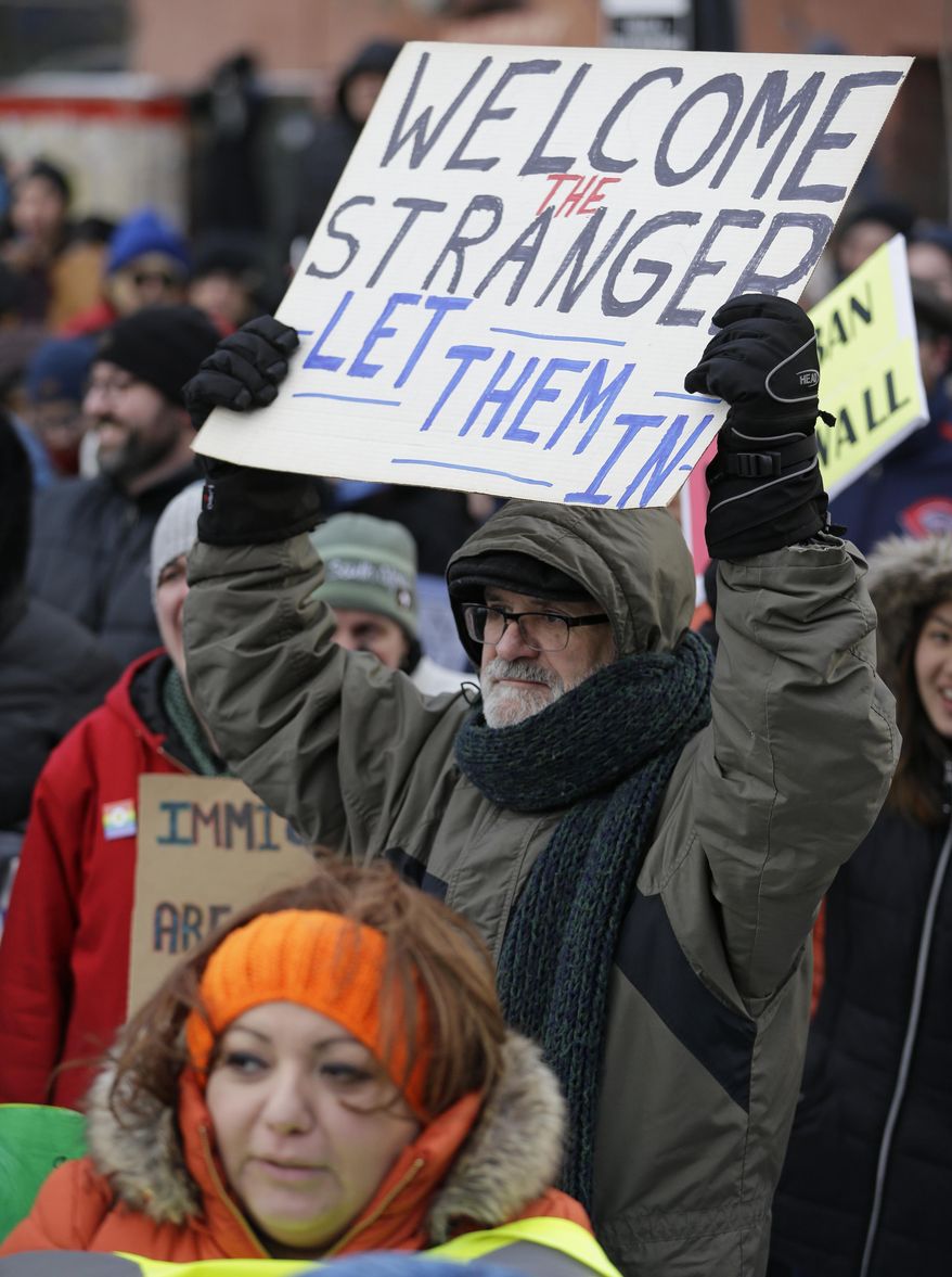 People protest at a demonstration in Market Square, Friday, Feb. 3, 2017, in Cleveland. The demonstration was organized in protest of President Donald Trump's immigration order. (AP Photo/Tony Dejak)