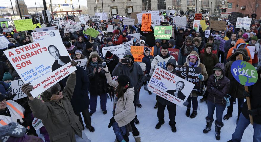 People protest at a demonstration in Market Square, Friday, Feb. 3, 2017, in Cleveland. The demonstration was organized in protest of President Donald Trump's immigration order. (AP Photo/Tony Dejak)
