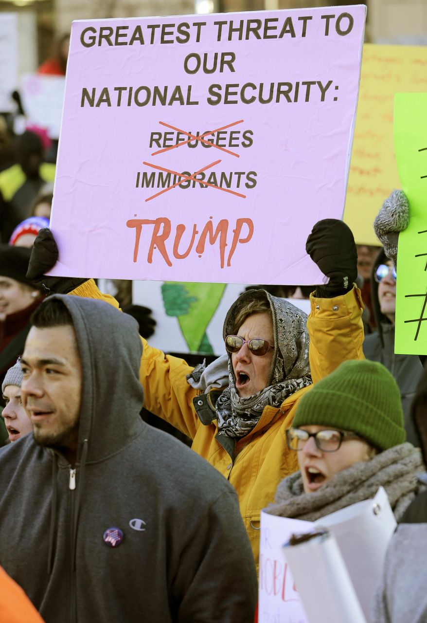 People protest in a demonstration at Market Square, Friday, Feb. 3, 2017, in Cleveland. The demonstration was organized in protest of President Donald Trump's immigration order. (AP Photo/Tony Dejak)