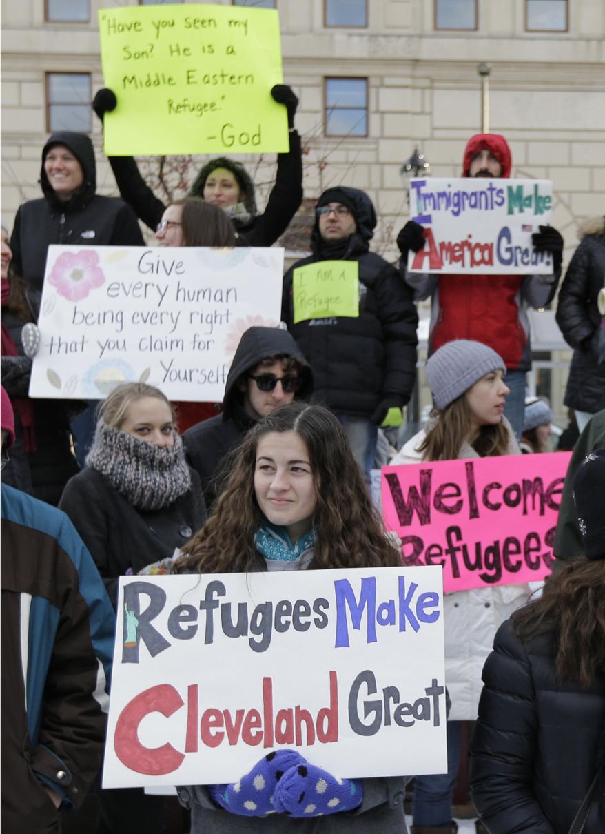 People protest at a demonstration in Market Square, Friday, Feb. 3, 2017, in Cleveland. The demonstration was organized in protest of President Donald Trump's immigration order. (AP Photo/Tony Dejak)