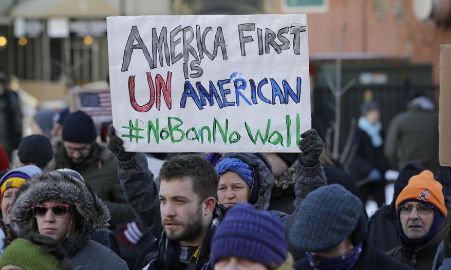 People protest at a demonstration in Market Square, Friday, Feb. 3, 2017, in Cleveland. The demonstration was organized in protest of President Donald Trump's immigration order. (AP Photo/Tony Dejak)