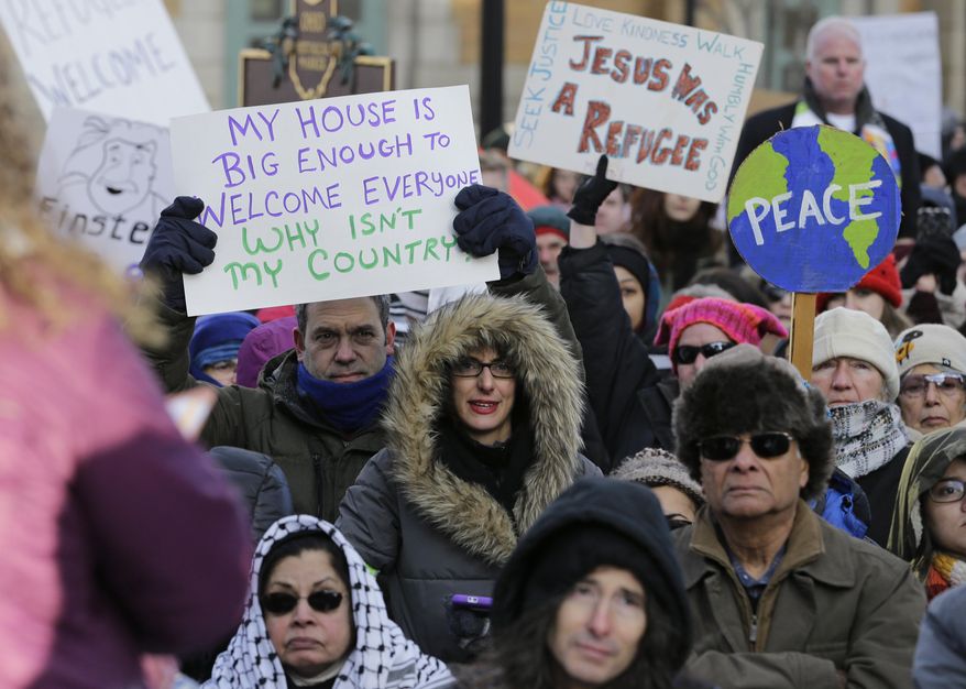 People protest at a demonstration in Market Square, Friday, Feb. 3, 2017, in Cleveland. The demonstration was organized in protest of President Donald Trump's immigration order. (AP Photo/Tony Dejak)