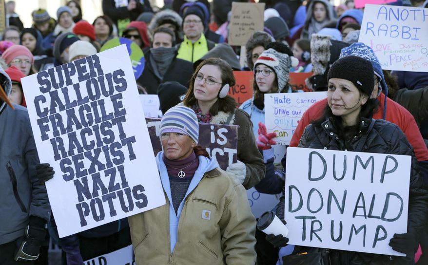 People protest in a demonstration at Market Square, Friday, Feb. 3, 2017, in Cleveland. The demonstration was organized in protest of President Donald Trump's immigration order. (AP Photo/Tony Dejak)