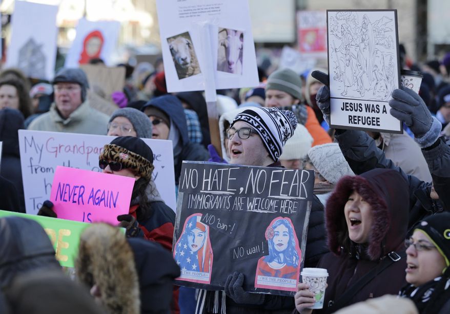 People protest at a demonstration in Market Square, Friday, Feb. 3, 2017, in Cleveland. The demonstration was organized in protest of President Donald Trump's immigration order. (AP Photo/Tony Dejak)