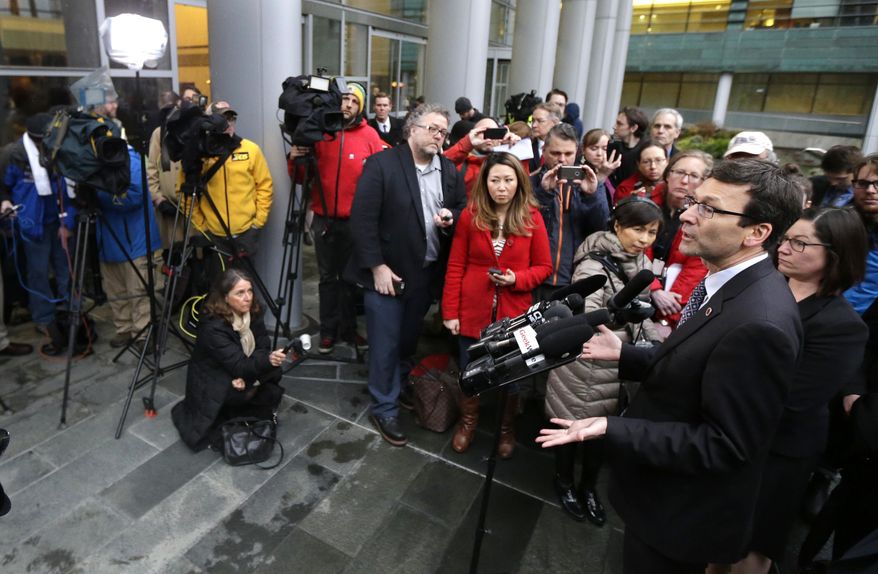 Washington Attorney General Bob Ferguson, right, talks to reporters Friday, Feb. 3, 2017, following a hearing in federal court in Seattle. A U.S. judge on Friday temporarily blocked President Donald Trump's ban on people from seven predominantly Muslim countries from entering the United States after Washington state and Minnesota urged a nationwide hold on the executive order that has launched legal battles across the country.(AP Photo/Ted S. Warren)
