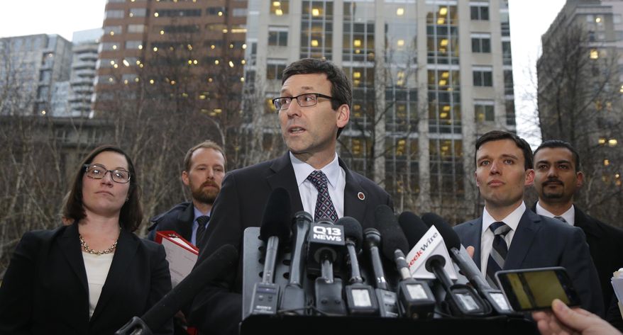 Washington Attorney General Bob Ferguson, center, talks to reporters as Solicitor General Noah Purcell, second from right, looks on, Friday, Feb. 3, 2017, following a hearing in federal court in Seattle. A U.S. judge on Friday temporarily blocked President Donald Trump's ban on people from seven predominantly Muslim countries from entering the United States after Washington state and Minnesota urged a nationwide hold on the executive order that has launched legal battles across the country. (AP Photo/Ted S. Warren)
