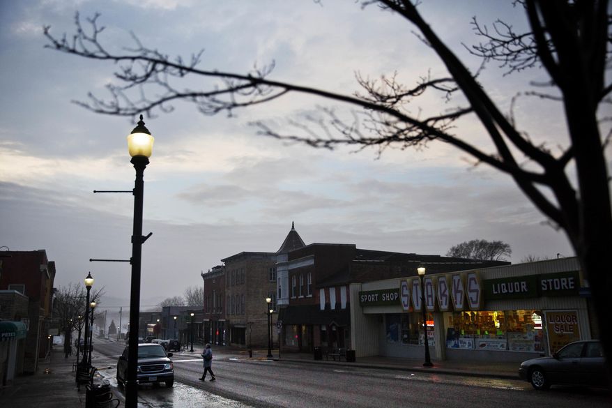 ADVANCE FOR USE TUESDAY, FEB. 7, 2017 AND THEREAFTER-A customer crosses the street while leaving a shop along the main business district in Prairie du Chien, Wis., in Crawford County, Thursday, Jan. 19, 2017. The county is one of dozens in middle America that switched from blue to red in November, but these Trump voters aren't looking for changes on immigration or refugees; if promises of an economic renaissance aren't fulfilled, they warn that Trump could be out four years from now. (AP Photo/David Goldman)