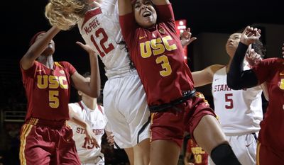 Southern California guard Minyon Moore (3) vies for a rebound against Stanford guard Brittany McPhee (12) during the first half of an NCAA college basketball game Friday, Feb. 3, 2017, in Stanford, Calif. (AP Photo/Marcio Jose Sanchez)