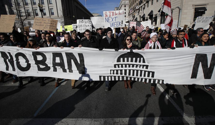 Protesters march from Lafayette Park near the White House in Washington, Saturday, Feb. 4, 2017, during a rally protesting the immigration policies of President Donald Trump. (AP Photo/Manuel Balce Ceneta)