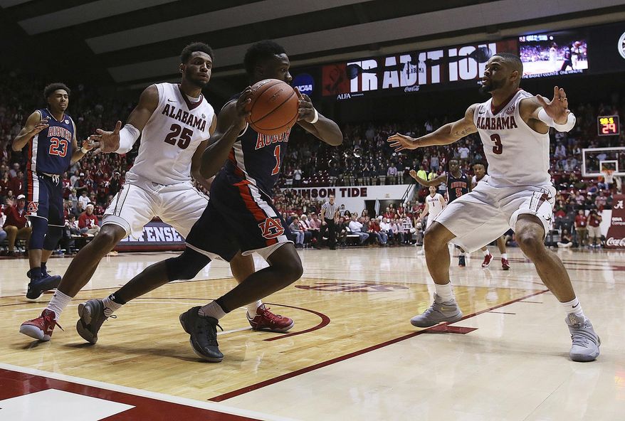 Auburn's Jared Harper (1) moves to get around Alabama's Braxton Key (25) and Corban Collins (3) during an NCAA college basketball game in Tuscaloosa, Ala., Saturday, Feb. 4, 2017. (Erin Nelson/The Tuscaloosa News via AP)