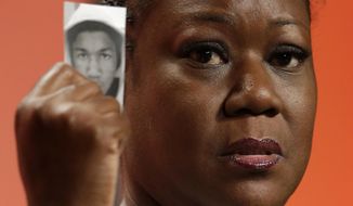 In this July 26, 2013, file photo, Sybrina Fulton, mother of Trayvon Martin, holds up a card with a photo of her son as she speaks at the National Urban League&#39;s annual conference in Philadelphia. Martin&#39;s parents are recounting the teen&#39;s killing and their fight for justice five years after his death. Martin&#39;s parents collaborated to write &amp;quot;Rest In Power: The Enduring Life of Trayvon Martin,&amp;quot; published Tuesday, Jan 31, 2017. (AP Photo/Matt Rourke, File) **FILE**