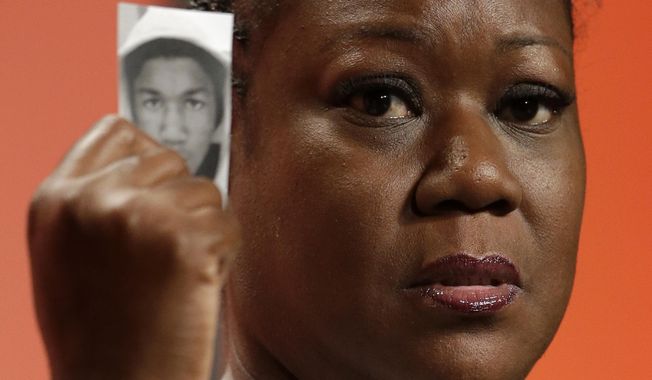 In this July 26, 2013, file photo, Sybrina Fulton, mother of Trayvon Martin, holds up a card with a photo of her son as she speaks at the National Urban League&#x27;s annual conference in Philadelphia. Martin&#x27;s parents are recounting the teen&#x27;s killing and their fight for justice five years after his death. Martin&#x27;s parents collaborated to write &amp;quot;Rest In Power: The Enduring Life of Trayvon Martin,&amp;quot; published Tuesday, Jan 31, 2017. (AP Photo/Matt Rourke, File) **FILE**