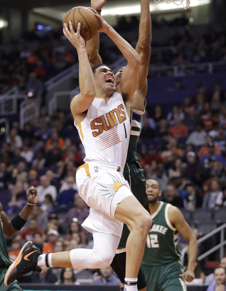 Phoenix Suns guard Devin Booker (1) tries to score as Milwaukee Bucks forward Giannis Antetokounmpo defends during the second half of an NBA basketball game, Saturday, Feb. 4, 2017, in Phoenix. (AP Photo/Matt York)