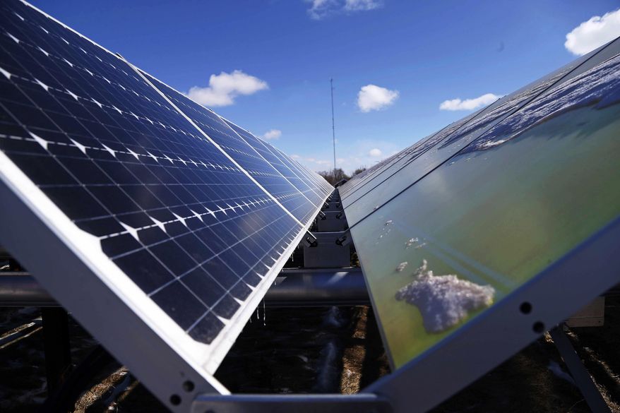 In this Feb. 26, 2015 file photo, solar panels that are part of the Wright-Hennepin Cooperative Electric Association's community gardens are shown in Rockford, Minn. Plunging solar power costs are leading U.S. electric companies to capture the sun just when President Donald Trump is moving to boost coal and other fossil fuels. Major electric utilities are moving into smaller-scale solar farming, a niche developed by local cooperatives and non-profits. (AP Photo/Jim Mone, File)