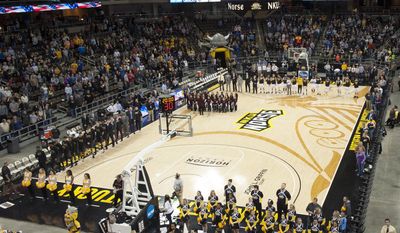 In this Friday, Jan. 20, 2017, photo provided by Northern Kentucky University, North Kentucky gets set to taken on Oakland (Mich.) in an NCAA college basketball game at BB&amp;amp;T Arena in Highland Heights, Ky. College basketball floors once had simple designs, the only flair usually the addition of color in the lane or at midcourt. Court designs have taken a creative twist over the past few years with schools adding elaborate detail. (Tim Sofranko/Northern Kentucky University via AP)