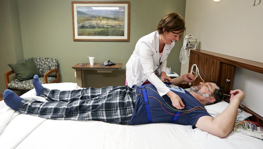 Sleep technician Tina Walsh prepares Jon Obe, of Dubuque, Iowa, for a sleep study at Mercy Medical Center-Dubuque's sleep lab. Over the past 15 years, sleep has become widely recognized as a critical aspect of good health, and new research has shed more light on its importance in cardiovascular, metabolic and immune health. (Nick Kohl /Telegraph Herald via AP) **FILE**