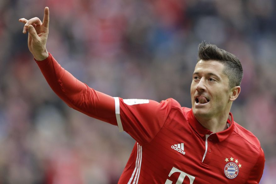 Bayern's Robert Lewandowski celebrates after scoring his side's opening goal during the German Bundesliga soccer match between FC Bayern Munich and FC Schalke 04 at the Allianz Arena stadium in Munich, Germany, Saturday, Feb. 4, 2017. (AP Photo/Matthias Schrader)