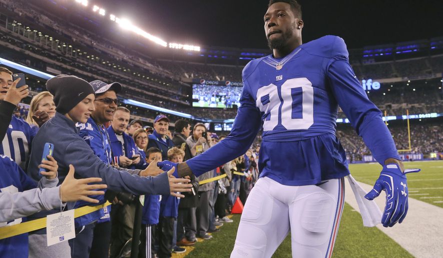 FILE - In this Nov. 14, 2016, file photo, New York Giants defensive end Jason Pierre-Paul (90) greets fans before an NFL football game against the Cincinnati Bengals, in East Rutherford, N.J. Pierre-Paul and ESPN have settled a lawsuit over the network's disclosure of his medical records from a 2015 fireworks accident. ESPN announced the settlement on Friday, Feb. 4, 2017, saying it believes that the network's reporting about the injury was newsworthy and journalistically appropriate. (AP Photo/Seth Wenig, File)