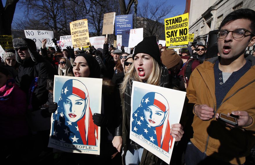 People chant during a rally protesting the immigration policies of President Donald Trump, near the White House in Washington, Saturday, Feb. 4, 2017. (AP Photo/Manuel Balce Ceneta)
