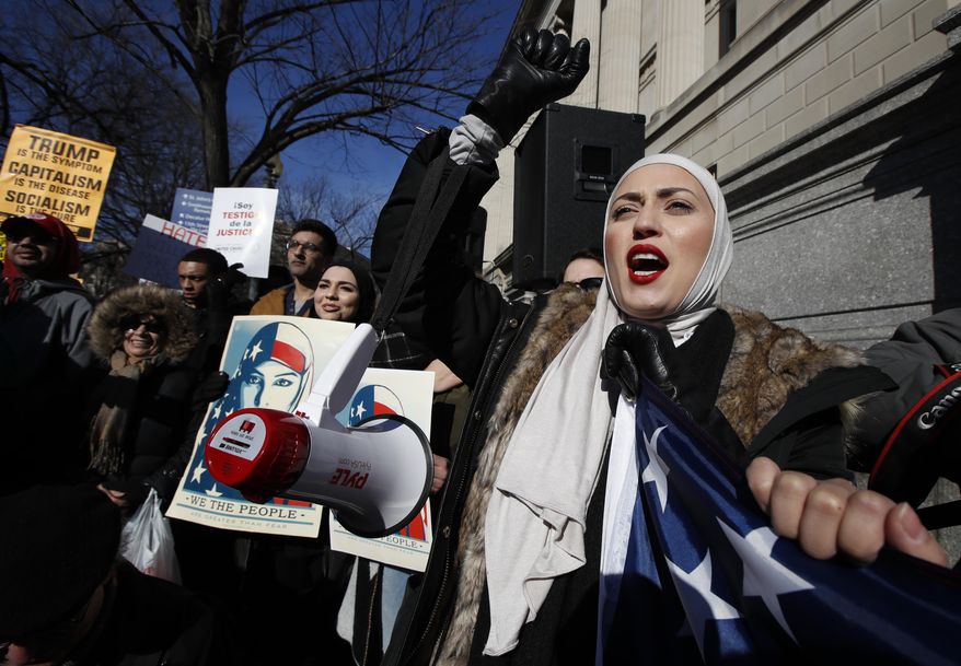 A demonstrator chants during a rally protesting the immigration policies of President Donald Trump, near the White House in Washington, Saturday, Feb. 4, 2017. (AP Photo/Manuel Balce Ceneta)
