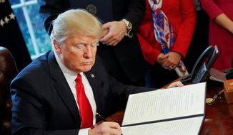 President Donald Trump signs an executive order in the Oval Office of the White House in Washington, Friday, Feb. 3, 2017. Trump signed an executive order that will direct the Treasury secretary to review the 2010 Dodd-Frank financial oversight law, which reshaped financial regulation after 2008-2009 crisis. (AP Photo/Pablo Martinez Monsivais) ** FILE **