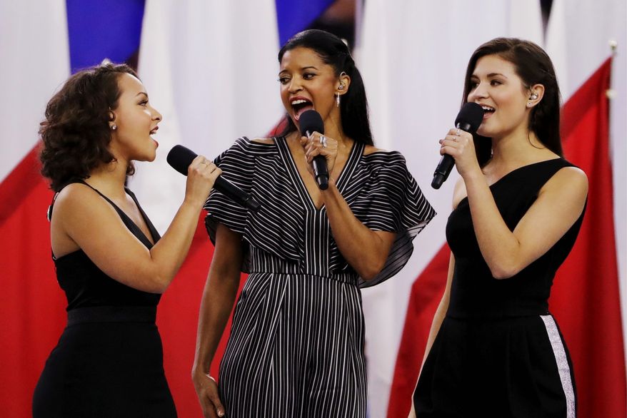 Singers of the cast of Hamilton, Phillipa Soo, right, Rene Elise Goldsberry, center, and Jasmine Cephas Jones, sing before the NFL Super Bowl 51 football game between the New England Patriots and the Atlanta Falcons, Sunday, Feb. 5, 2017, in Houston. (AP Photo/Matt Slocum)