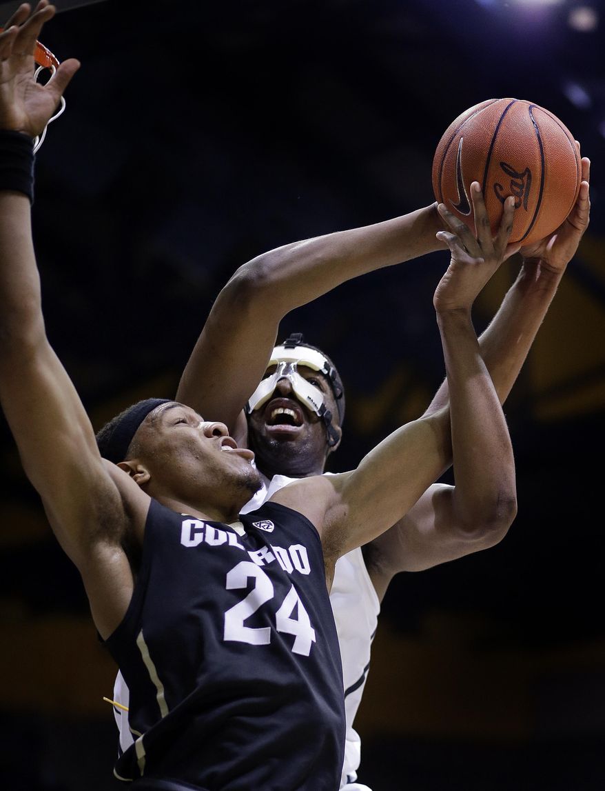 Colorado's George King (24) and California's Kingsley Okoroh fight for a rebound in the first half of an NCAA college basketball game Sunday, Feb. 5, 2017, in Berkeley, Calif. (AP Photo/Ben Margot)