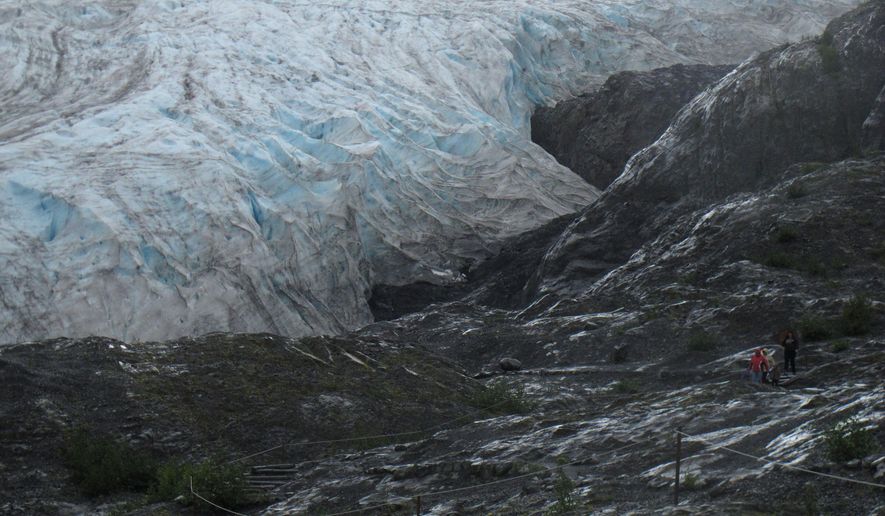 In this Aug. 4, 2012, file photo, tourists walk to Exit Glacier in Kenai Fjords National Park just outside Seward, Alaska. (AP Photo/Mark Thiessen) ** FILE **
