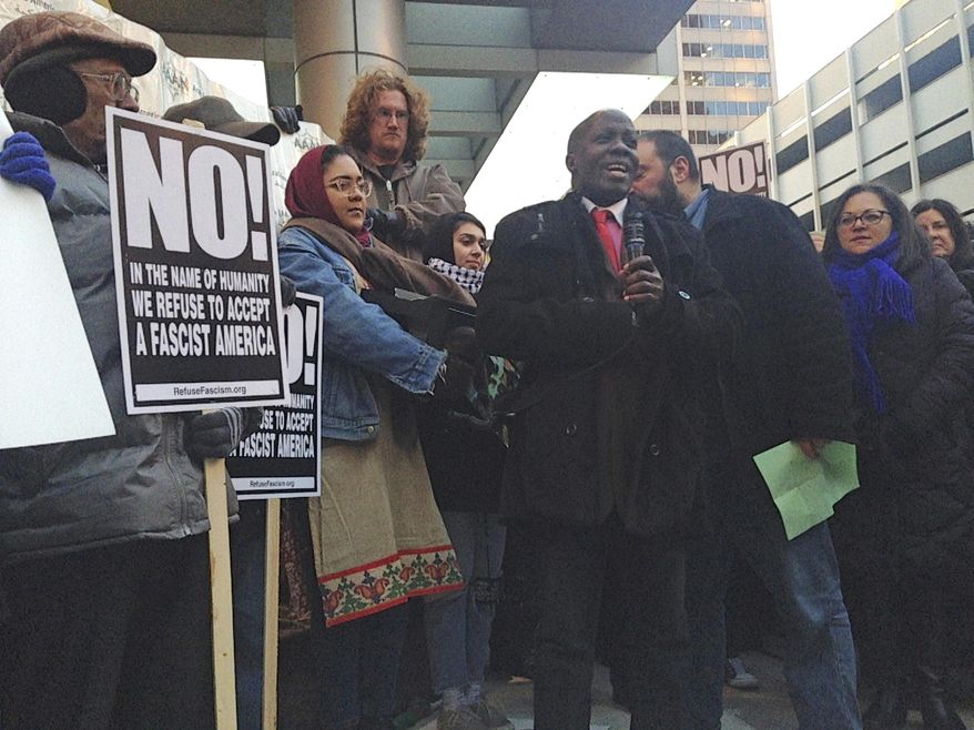 FILE - In this Feb. 1, 2017 photo, immigrant rights advocates protest President Donald Trump's executive orders on immigration in Chicago. State legislators are attempting to boost immigrant protections in response to President Donald Trump's forceful orders on immigration, a move advocates say would essentially make Illinois a "sanctuary" state. One proposal says schools, medical facilities and places of worship don't have to give access to federal immigration authorities or local law enforcement working on their behalf.(AP Photo by Sophia Tareen).