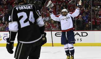 Washington Capitals left wing Alex Ovechkin, right, of Russia, celebrates a goal scored by  right wing T.J. Oshie (not shown) in front of Los Angeles Kings left wing Derek Forbort (24) during the second period of an NHL hockey game, Sunday, Feb. 5, 2017, in Washington. (AP Photo/Molly Riley)