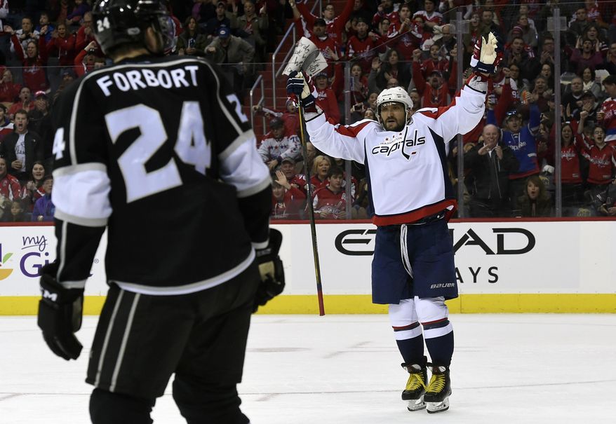 Washington Capitals left wing Alex Ovechkin, right, of Russia, celebrates a goal scored by right wing T.J. Oshie (not shown) in front of Los Angeles Kings left wing Derek Forbort (24) during the second period of an NHL hockey game, Sunday, Feb. 5, 2017, in Washington. (AP Photo/Molly Riley)