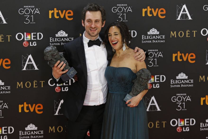 Spanish actor and director Raul Arevalo, left, poses with his trophies for best new director and best film with producer Beatriz Bodegas for their roles in the movie "Tarde para la ira" during the Goya Film Awards Ceremony in Madrid, Saturday, Feb. 4, 2017. The Goya Awards are Spain's main national annual film awards. (AP Photo/Francisco Seco)