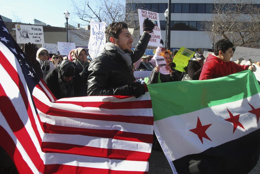 Anas Allouz pumps his fist in the air to protest against President Donald Trump's executive order during a rally on Public Square in Wilkes Barre, Pa., Saturday, Feb. 4, 2017. (Dave Scherbenco/The Citizens' Voice via AP)