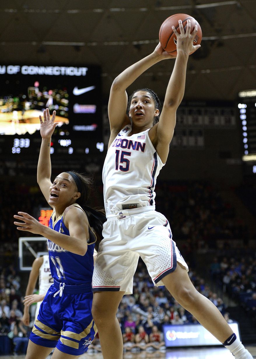 Connecticut&#39;s Gabby Williams (15) reaches for a rebound over Tulsa&#39;s Ebony Parker, left, in the half of an NCAA college basketball game, Sunday, Feb. 5, 2017, in Storrs, Conn. (AP Photo/Jessica Hill)