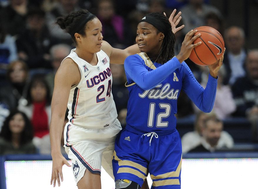 Tulsa&#39;s Shug Dickson, right, keeps the ball from Connecticut&#39;s Napheesa Collier, left, in the half of an NCAA college basketball game, Sunday, Feb. 5, 2017, in Storrs, Conn. (AP Photo/Jessica Hill)